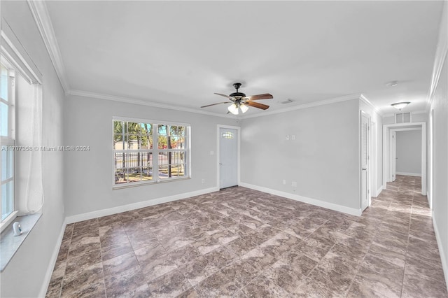 empty room featuring ceiling fan and ornamental molding