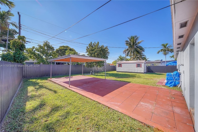 view of yard with a storage unit and a patio area