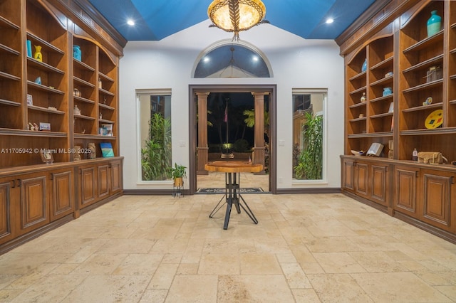 unfurnished room with vaulted ceiling