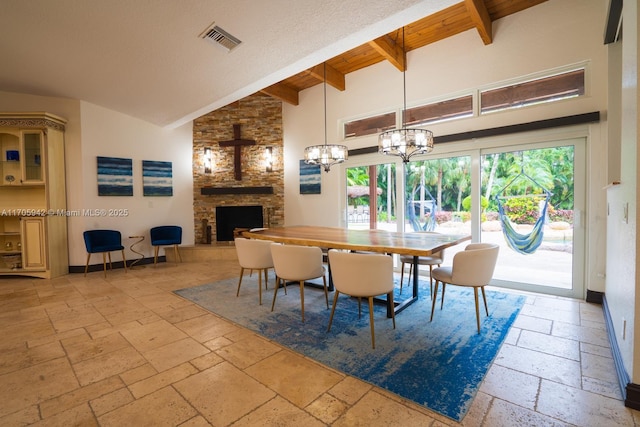 dining area featuring a stone fireplace, high vaulted ceiling, wooden ceiling, a notable chandelier, and beamed ceiling