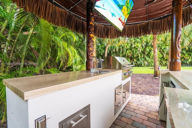 view of patio / terrace with area for grilling and a gazebo