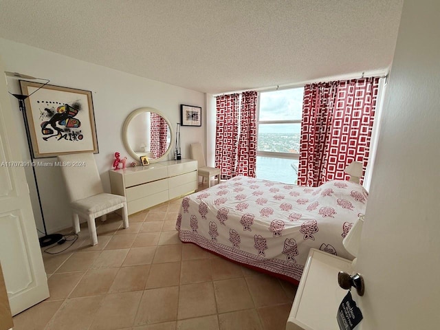 bedroom with light tile patterned floors and a textured ceiling