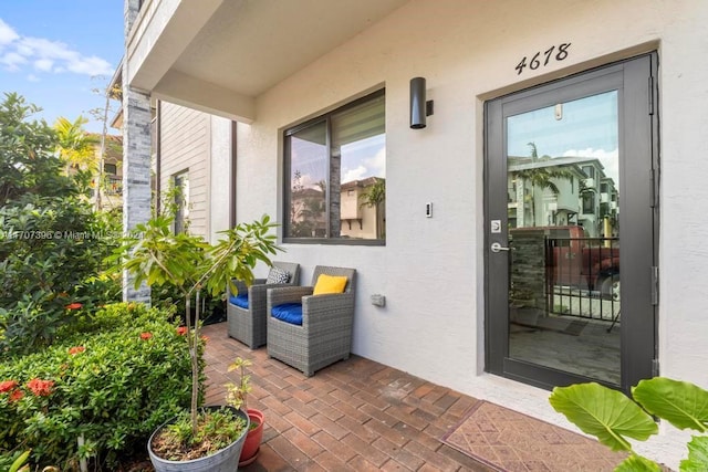 view of exterior entry featuring a patio area