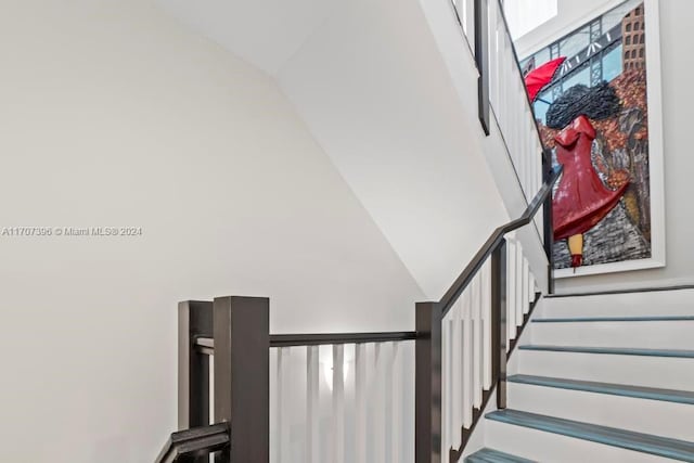 stairway featuring vaulted ceiling