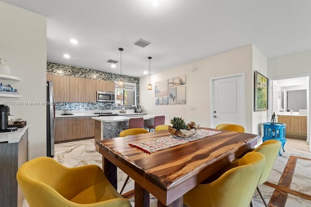 dining space featuring sink