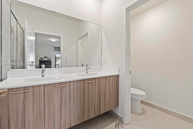 bathroom with tile patterned floors, vanity, and toilet