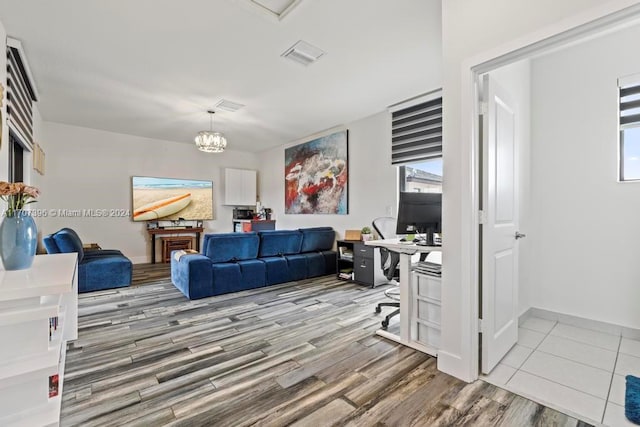 office area with a chandelier and light hardwood / wood-style floors