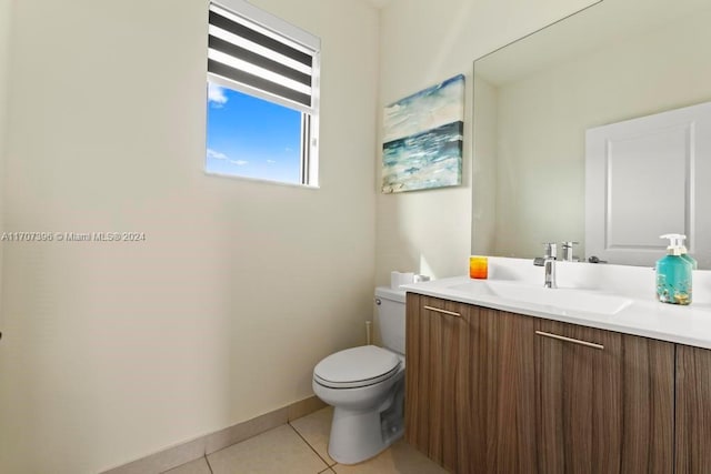 bathroom with tile patterned flooring, vanity, and toilet