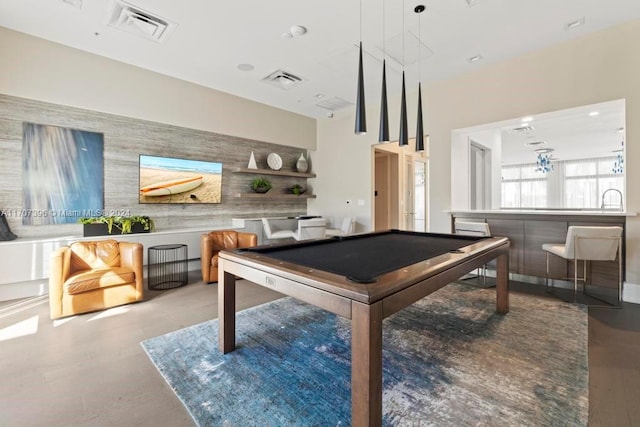 recreation room featuring bar, wood-type flooring, and billiards