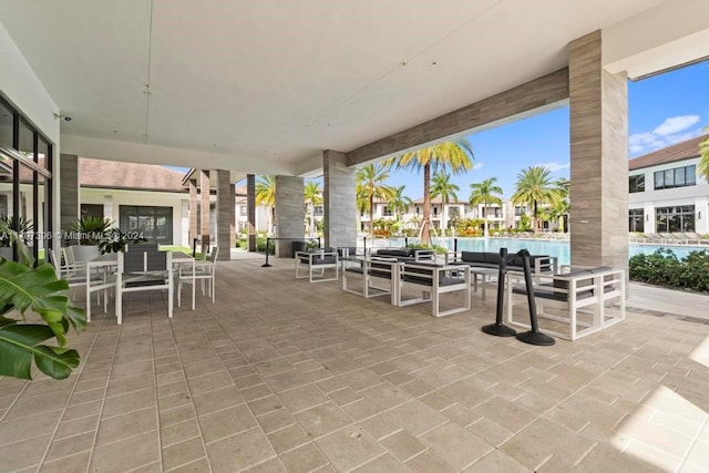 view of patio featuring outdoor lounge area and a community pool