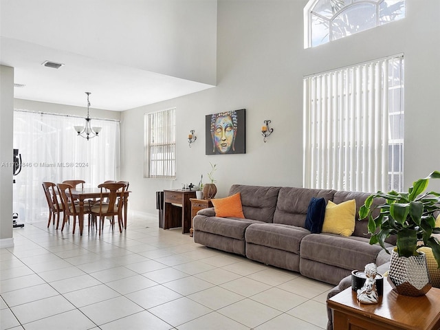 tiled living room with a notable chandelier