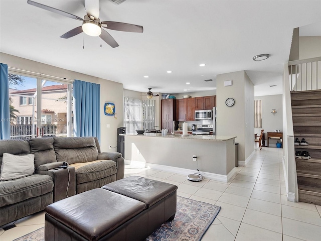 living room with ceiling fan and light tile patterned flooring