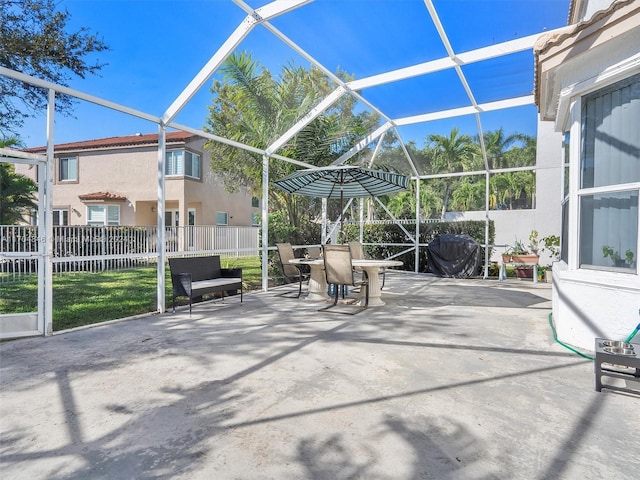 view of patio featuring glass enclosure