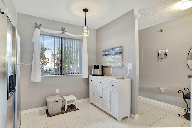 bathroom featuring tile patterned flooring and a textured ceiling