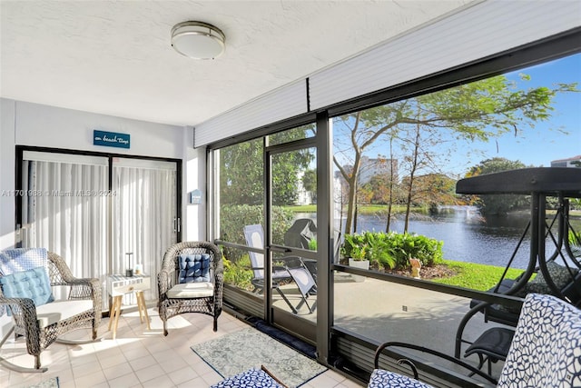 sunroom / solarium featuring a water view