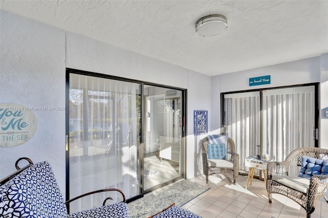 interior space with tile patterned flooring and a textured ceiling