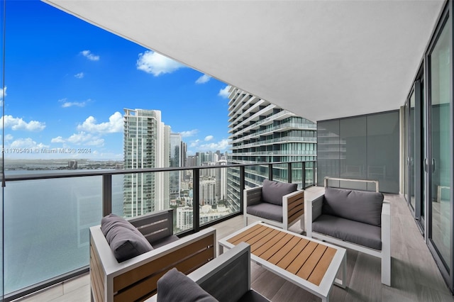 balcony featuring a water view and an outdoor hangout area