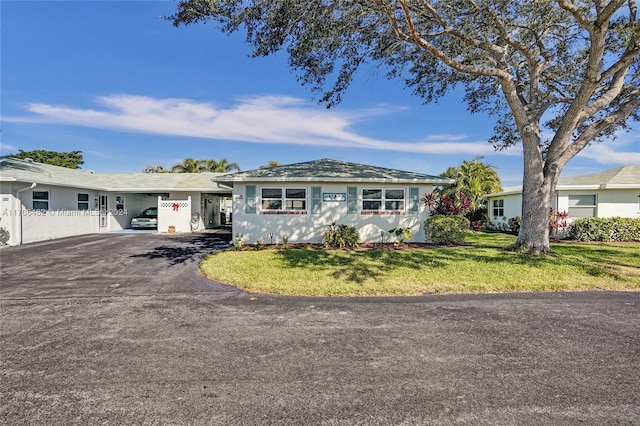 ranch-style house with a carport and a front lawn