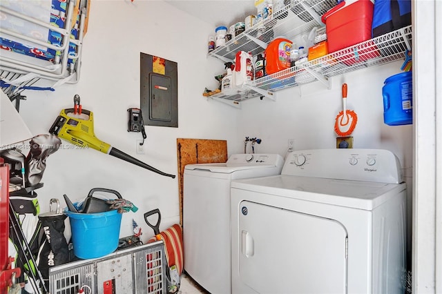 laundry area with washing machine and clothes dryer and electric panel