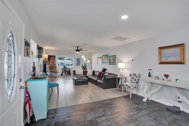 living room with dark hardwood / wood-style floors and ceiling fan