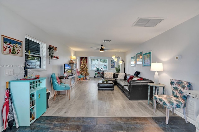 living room featuring ceiling fan and hardwood / wood-style floors