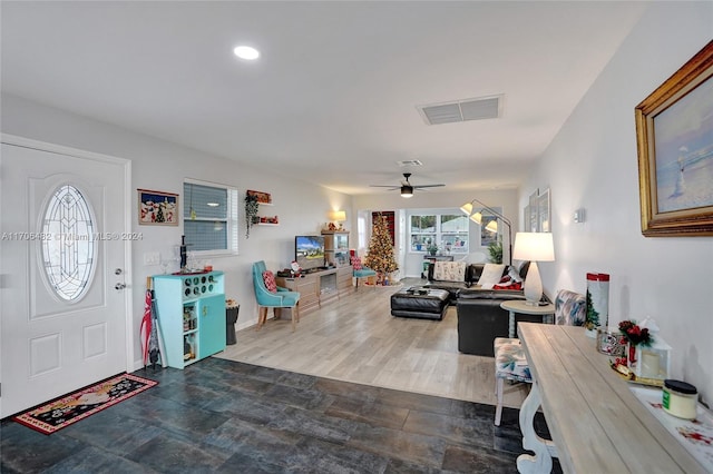 foyer entrance featuring ceiling fan and wood-type flooring