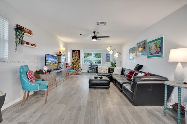 living room with ceiling fan and light wood-type flooring