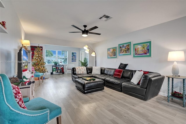 living room featuring ceiling fan and light hardwood / wood-style floors