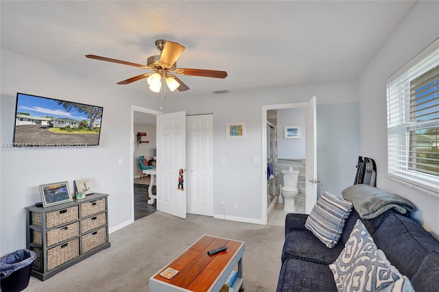 carpeted living room featuring ceiling fan