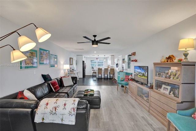 living room with hardwood / wood-style floors and ceiling fan