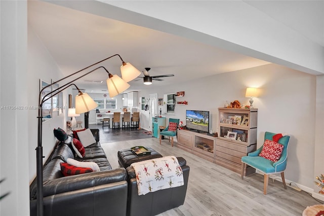 living room with ceiling fan and light hardwood / wood-style floors