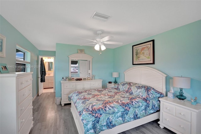 bedroom featuring hardwood / wood-style flooring, ceiling fan, and ensuite bathroom