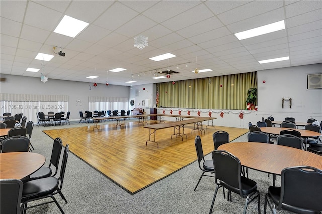 dining room featuring hardwood / wood-style flooring and a drop ceiling