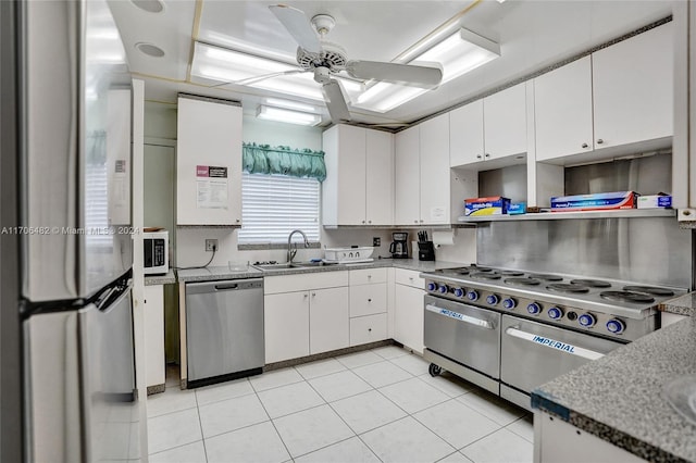 kitchen featuring white cabinetry, sink, ceiling fan, light tile patterned floors, and appliances with stainless steel finishes