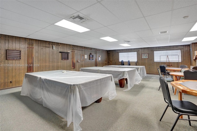 recreation room with a paneled ceiling, wooden walls, and pool table