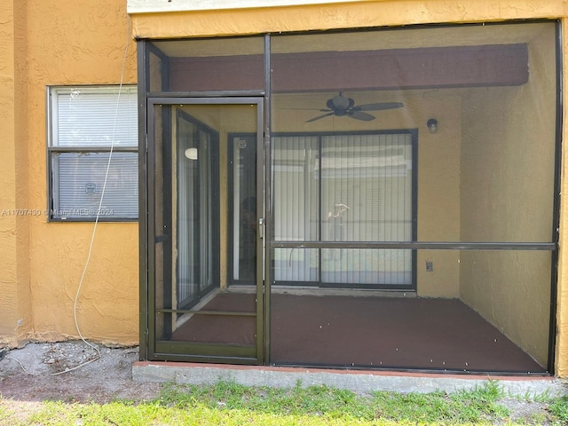 view of exterior entry featuring ceiling fan