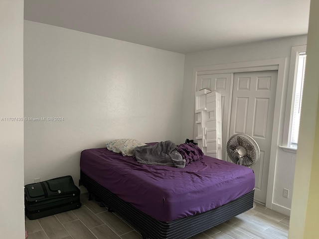 bedroom with light wood-type flooring and a closet