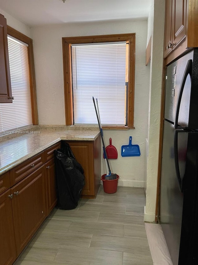 clothes washing area with light hardwood / wood-style floors