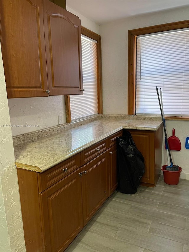 kitchen featuring light stone countertops and light wood-type flooring