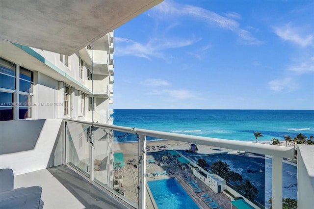 balcony featuring a water view and a beach view