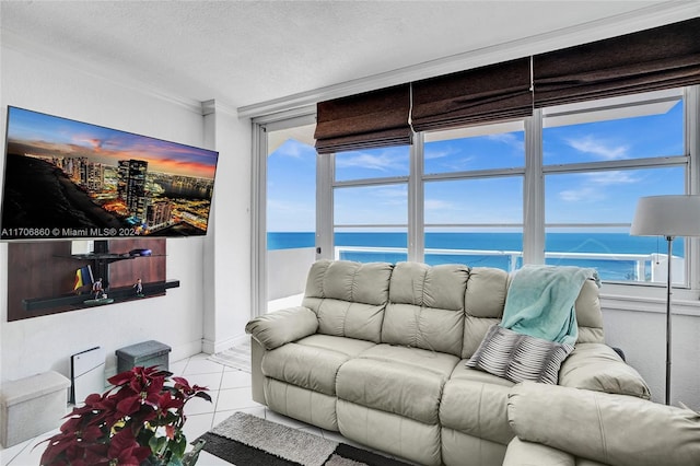 tiled living room with a textured ceiling, a water view, a wealth of natural light, and crown molding