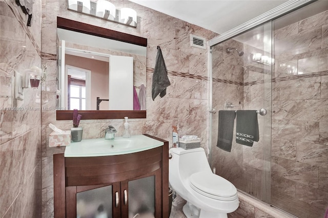 bathroom featuring decorative backsplash, an enclosed shower, vanity, tile walls, and toilet