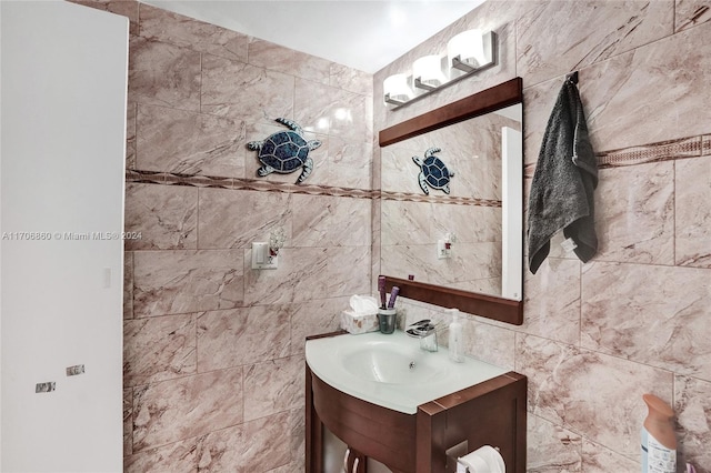 bathroom featuring vanity and tile walls