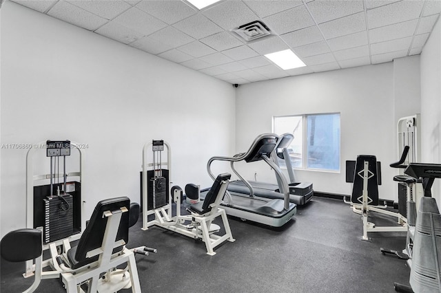 gym with a paneled ceiling