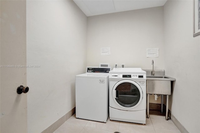 washroom featuring separate washer and dryer and light tile patterned flooring