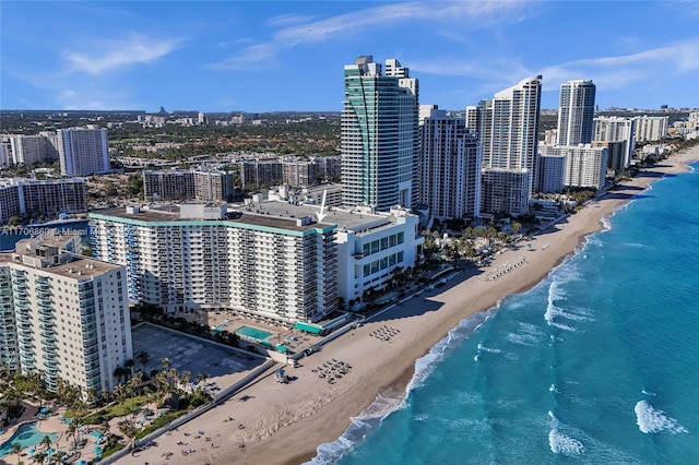 view of city featuring a beach view and a water view