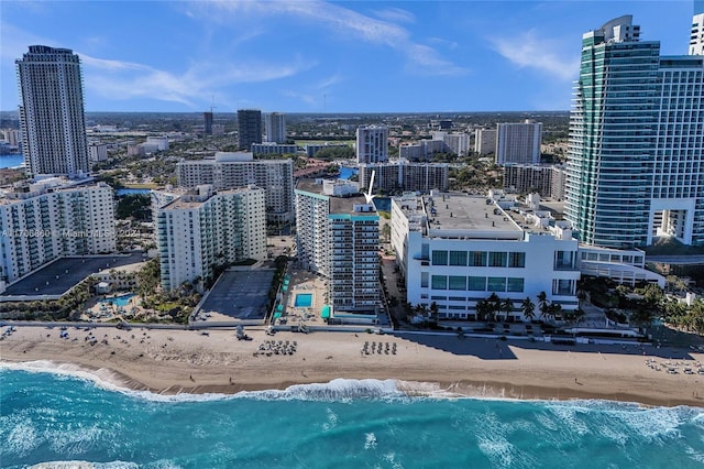 property's view of city with a water view and a beach view