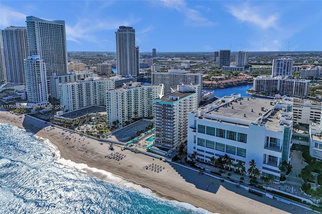 drone / aerial view featuring a water view and a view of the beach