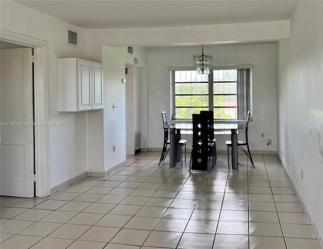 unfurnished dining area featuring light tile patterned flooring and a chandelier