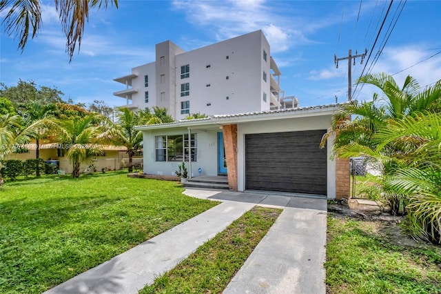 view of front facade featuring a front yard and a garage